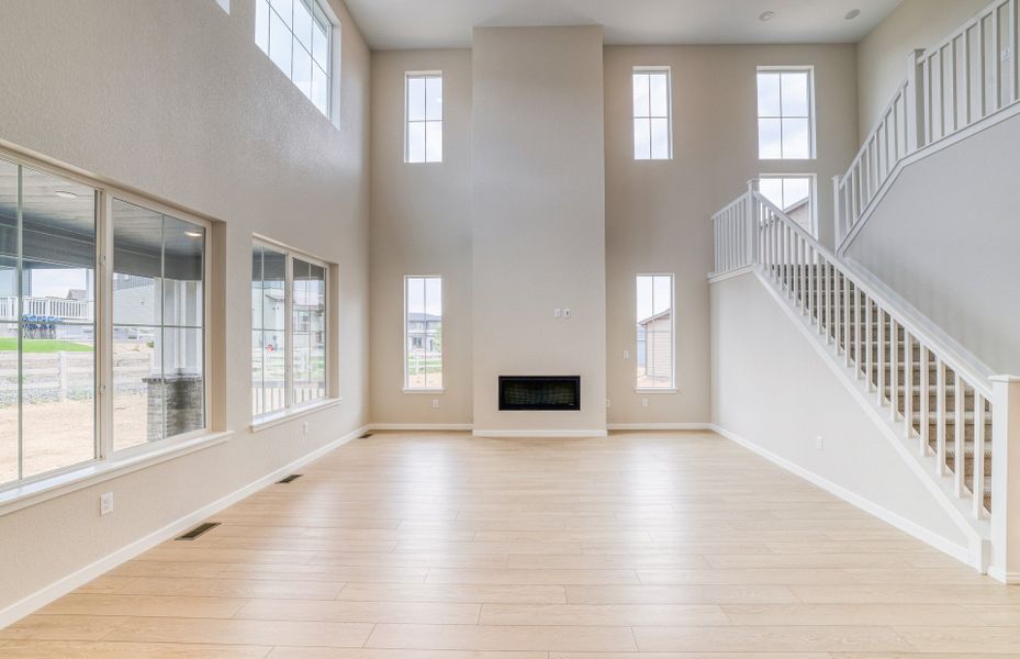 Inviting Gathering Room featuring a cozy fireplace and natural lighting