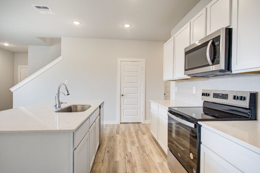 A kitchen with white cabinets. A kitchen with white cabinets.