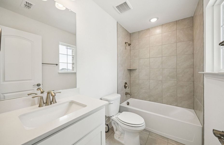 Elegant secondary bath with contemporary design  *Real home pictured