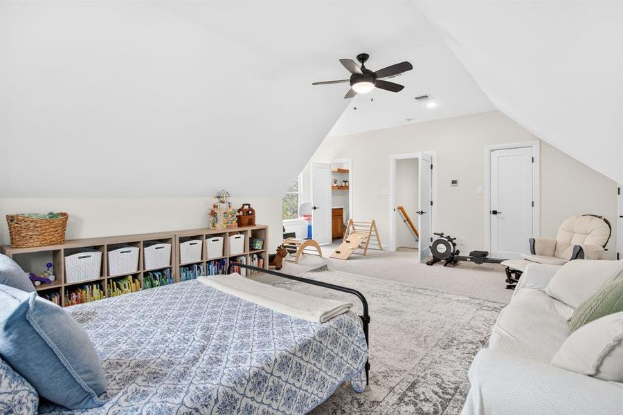 Bedroom with lofted ceiling, ceiling fan, and carpet floors Bedroom with lofted ceiling, ceiling fan, and carpet floors