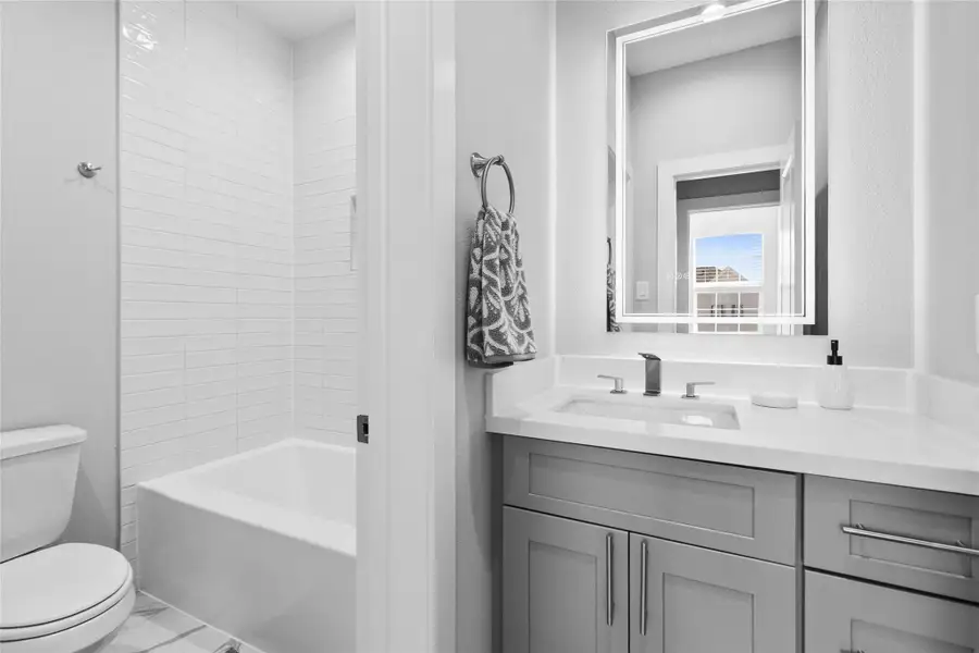 Clean, polished, and timeless, this bathroom delivers a crisp tub-and-shower combo with classic tilework and a modern vanity that ties everything together. Perfect for guests or secondary bedrooms, it feels fresh, finished, and ready from day one. Clean, polished, and timeless, this bathroom delivers a crisp tub-and-shower combo with classic tilework and a modern vanity that ties everything together. Perfect for guests or secondary bedrooms, it feels fresh, finished, and ready from day one.