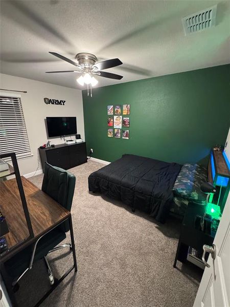 Room 3 featuring neutral carpeting and a green accent wall