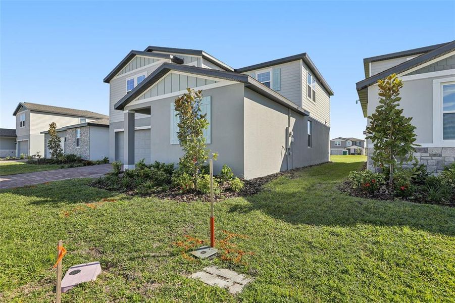 Front exterior of a new home in The Reserve at Twin Lakes, St. Cloud, FL, highlighting curb appeal (Image 2). Front exterior of a new home in The Reserve at Twin Lakes, St. Cloud, FL, highlighting curb appeal (Image 2).