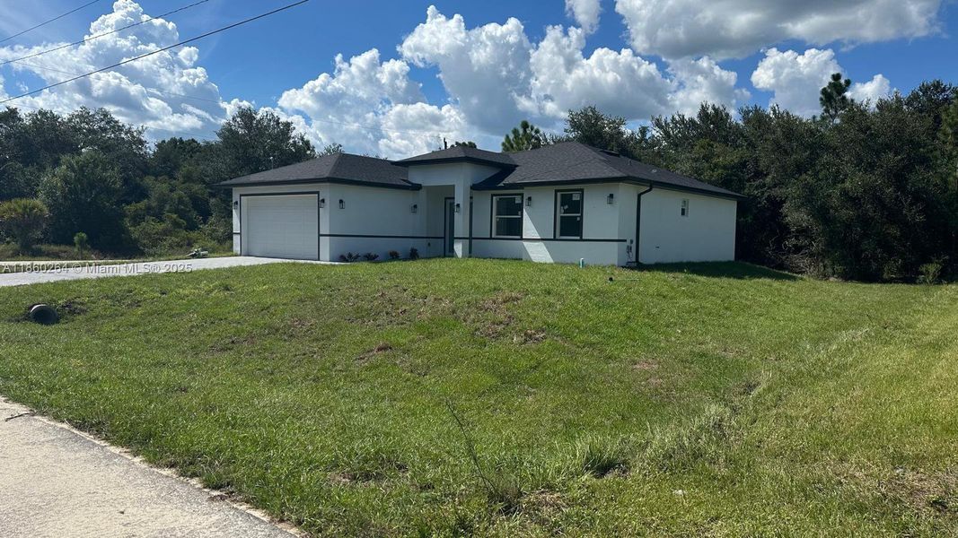 Front exterior of a new home in , Lehigh Acres, FL, highlighting curb appeal (Image 1). Front exterior of a new home in , Lehigh Acres, FL, highlighting curb appeal (Image 1).