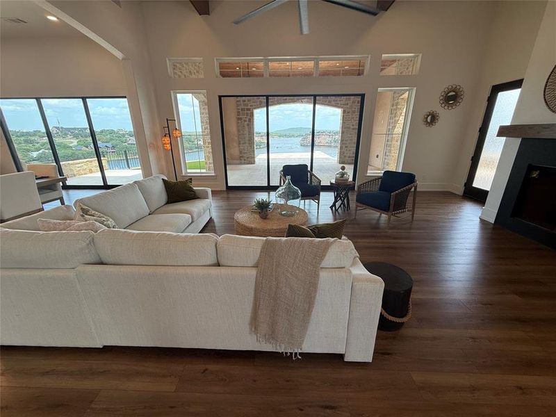 Living room with a high ceiling and dark wood-style floors Living room with a high ceiling and dark wood-style floors