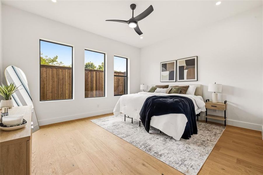 Bright interior space featuring light wood-finish flooring, recessed lighting, and a modern ceiling fan