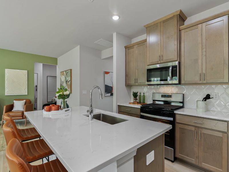 The kitchen provides ample prep and storage space with a sizeable island overlooking the great room.