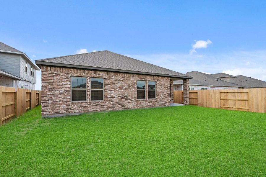 Exterior details and patio area of a home in Windrose Green, Angleton (Image 26).