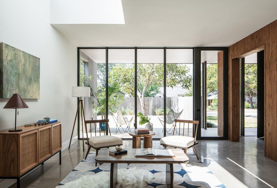 Sitting room with finished concrete flooring and floor to ceiling windows