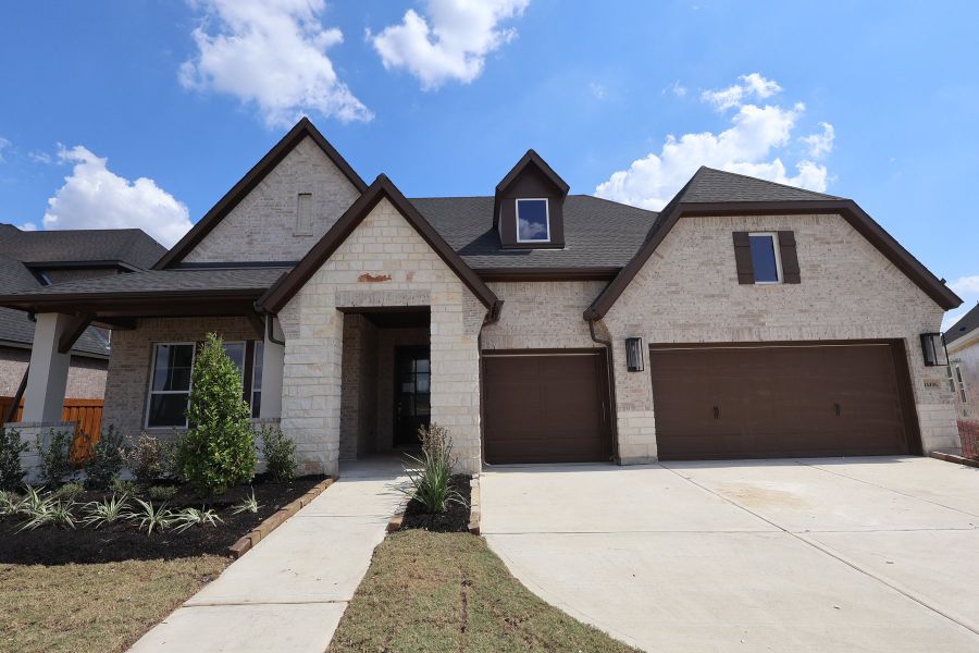 Front exterior of a new home in Dunham Pointe - Parkview Collection, Cypress, TX, highlighting curb appeal (Image 1). Front exterior of a new home in Dunham Pointe - Parkview Collection, Cypress, TX, highlighting curb appeal (Image 1).