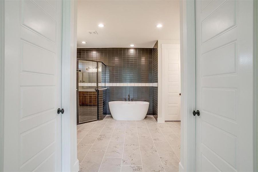 Bathroom featuring tile floors and separate shower and tub