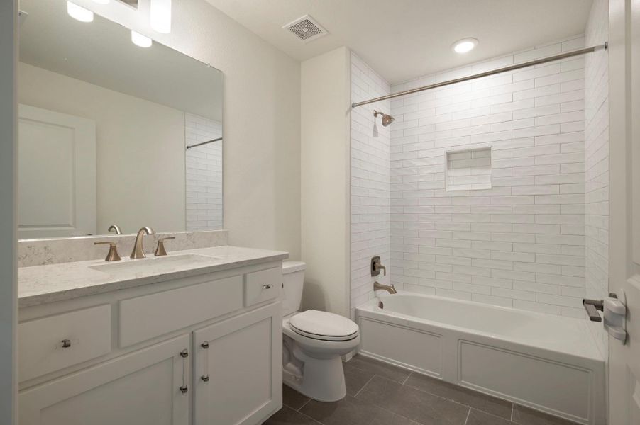 Upstairs bathroom with tub / shower combination, vanity, and dark tile patterned flooring Upstairs bathroom with tub / shower combination, vanity, and dark tile patterned flooring