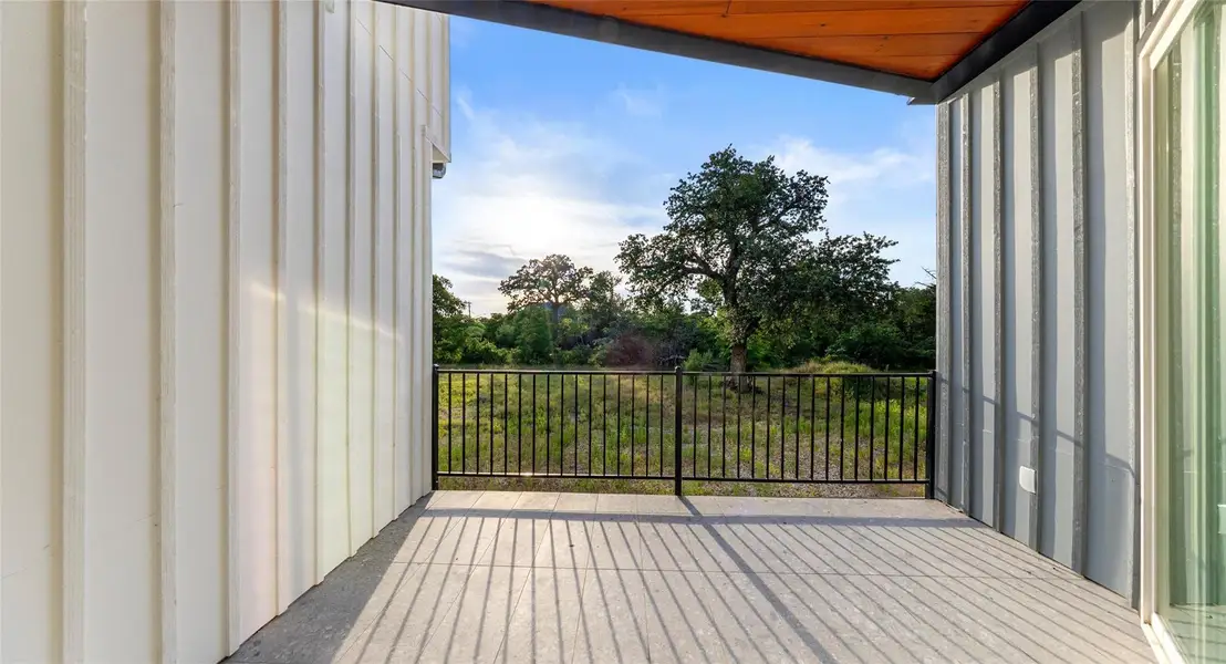 A private covered balcony made for slowing down — enjoy a glass of wine and the East Austin sunset, or morning coffee in the open air. Model No. 104 Shown.
