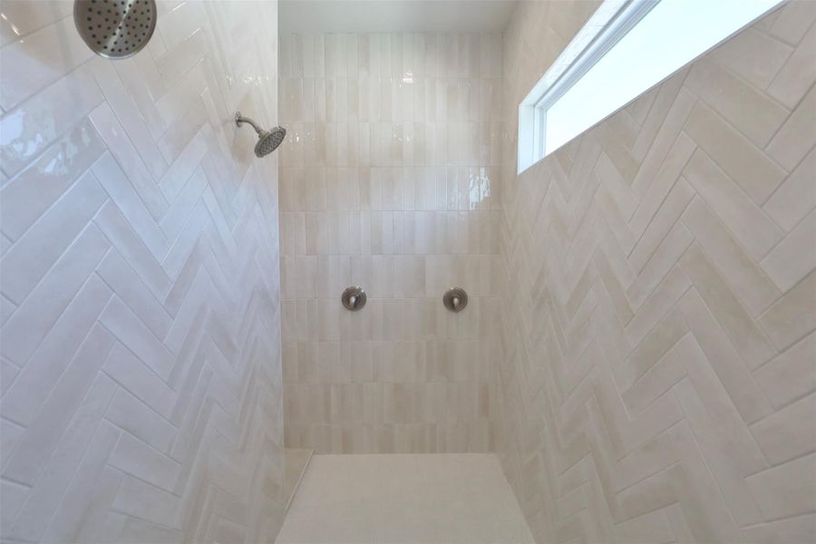 Trim valves thoughtfully placed on the shower wall sides, away from the showerheads, for clean aesthetics.Custom mitered-edge niche provides elegant storage for shower essentials. Trim valves thoughtfully placed on the shower wall sides, away from the showerheads, for clean aesthetics.Custom mitered-edge niche provides elegant storage for shower essentials.