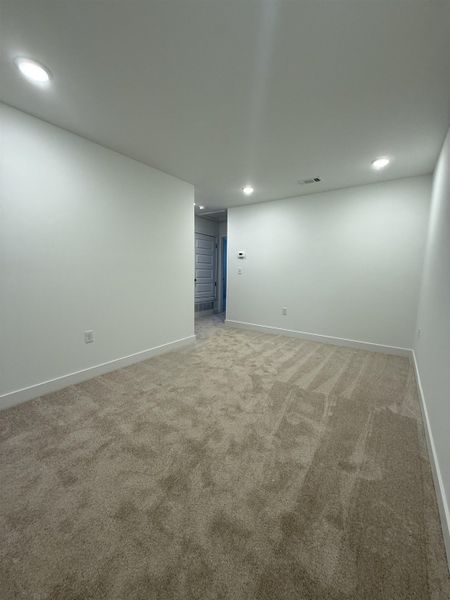 Spare room with recessed lighting and light carpet