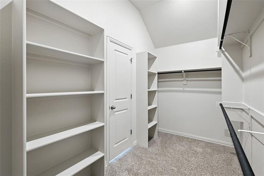 Spacious closet with light carpet Spacious closet with light carpet