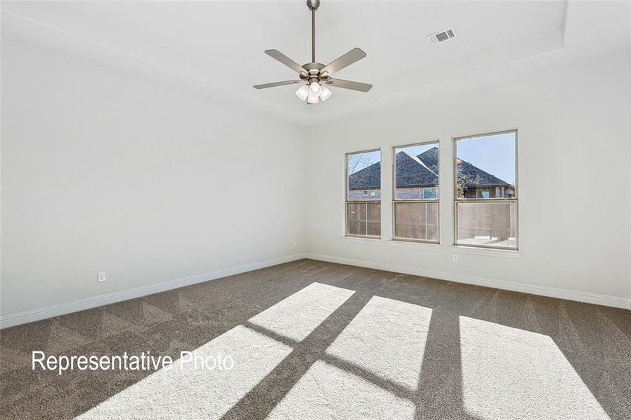 Carpeted spare room with ceiling fan