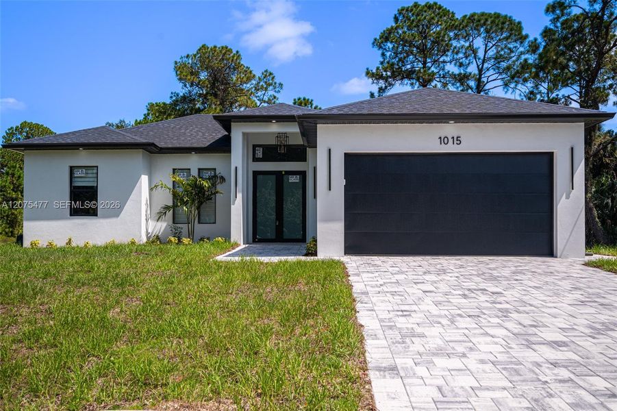 Front exterior of a new home in , Lehigh Acres, FL, highlighting curb appeal (Image 33). Front exterior of a new home in , Lehigh Acres, FL, highlighting curb appeal (Image 33).