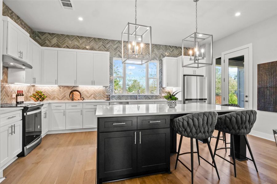 Kitchen featuring appliances with stainless steel finishes, white cabinetry, light countertops, and recessed lighting Kitchen featuring appliances with stainless steel finishes, white cabinetry, light countertops, and recessed lighting