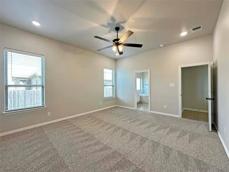 Unfurnished bedroom with ensuite bath, recessed lighting, carpet floors, and ceiling fan Unfurnished bedroom with ensuite bath, recessed lighting, carpet floors, and ceiling fan