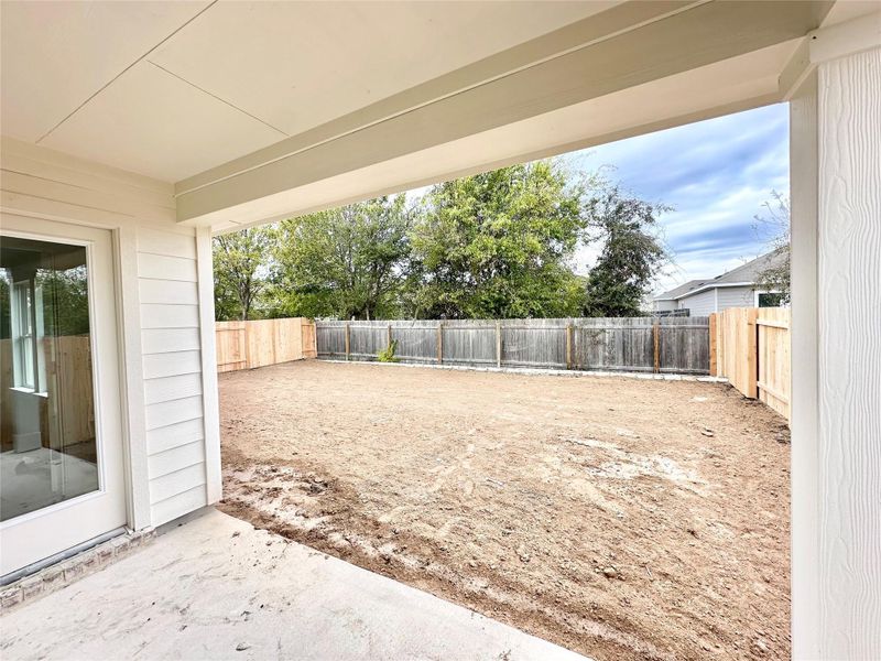 Fenced backyard featuring a patio