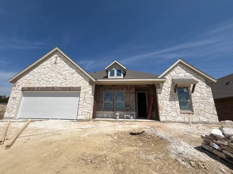 Front exterior of a new home in Waterford Park, Weatherford, TX, highlighting curb appeal (Image 1). Front exterior of a new home in Waterford Park, Weatherford, TX, highlighting curb appeal (Image 1).