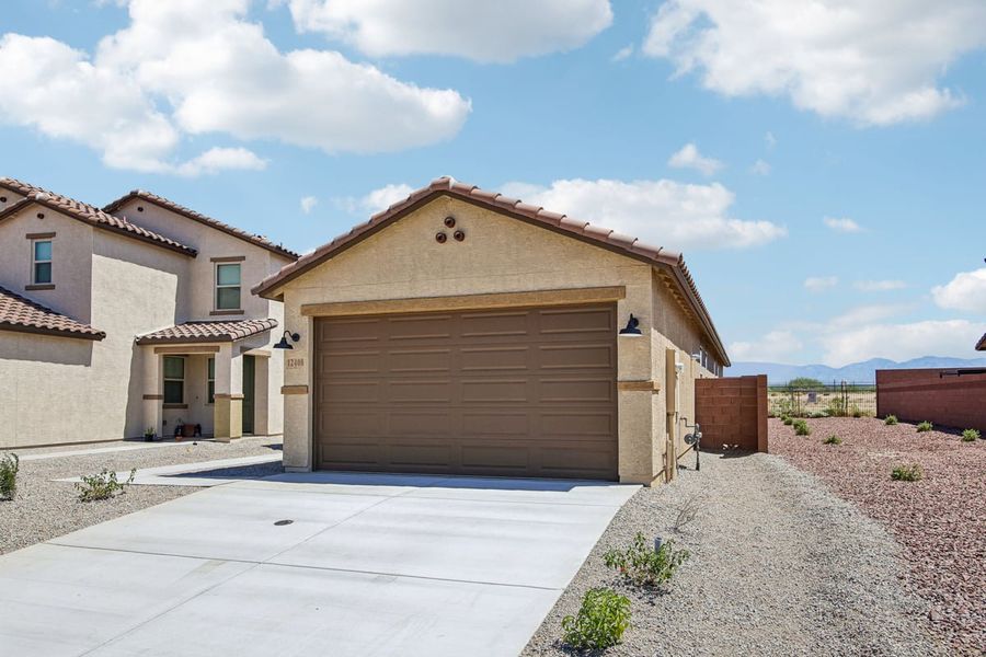 Front exterior of a new home in Mandarina Reserve, Marana, AZ, highlighting curb appeal (Image 20).