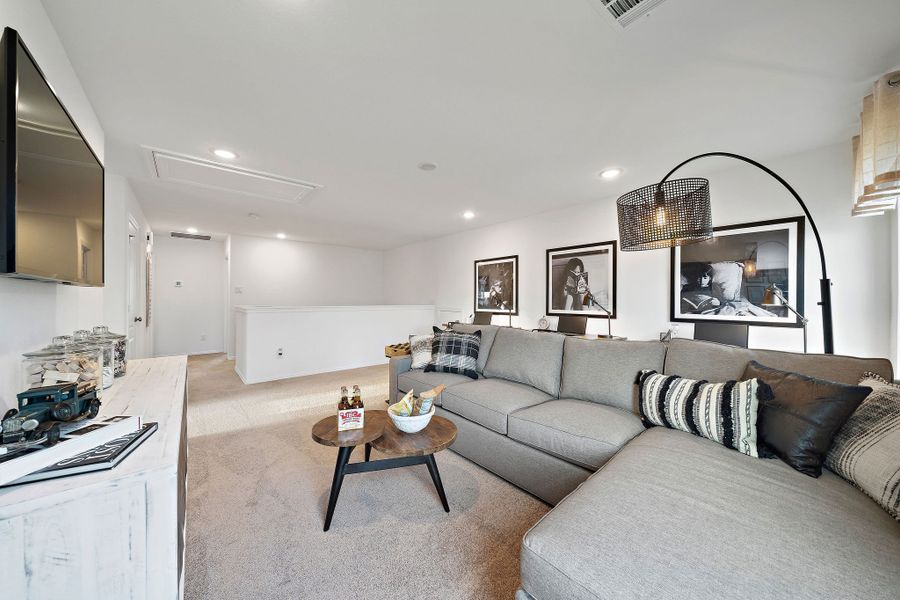 A living room with a couch and a table. A living room with a couch and a table.