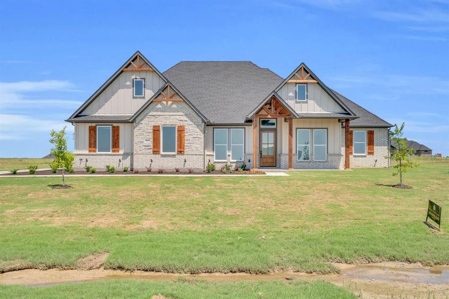 Craftsman-style house with a front yard