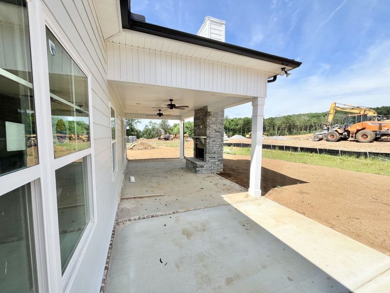 Actual home with Jumbo porch and Stone fireplace and additional uncovered patio for grill or just lounging in the sun.