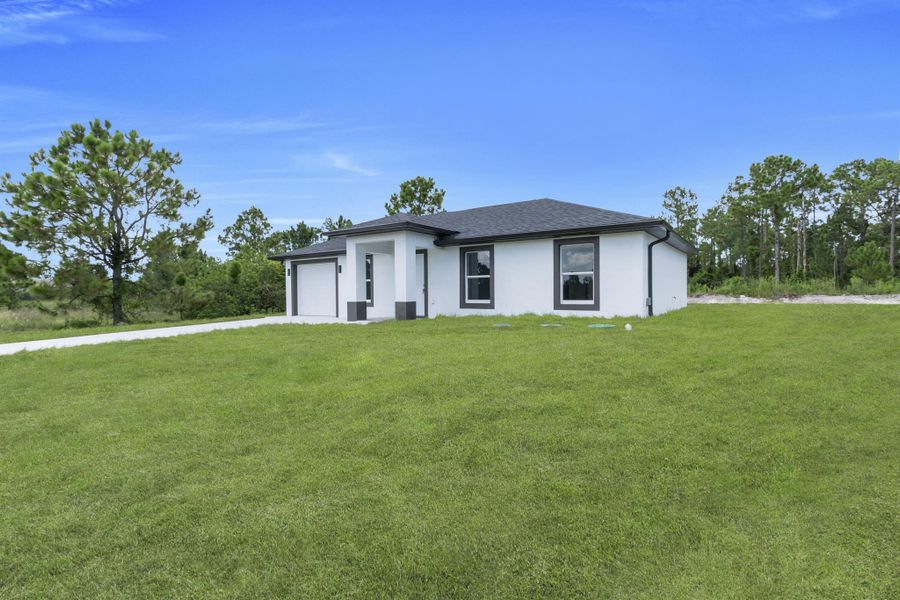 Front exterior of a new home in , Lehigh Acres, FL, highlighting curb appeal (Image 16).