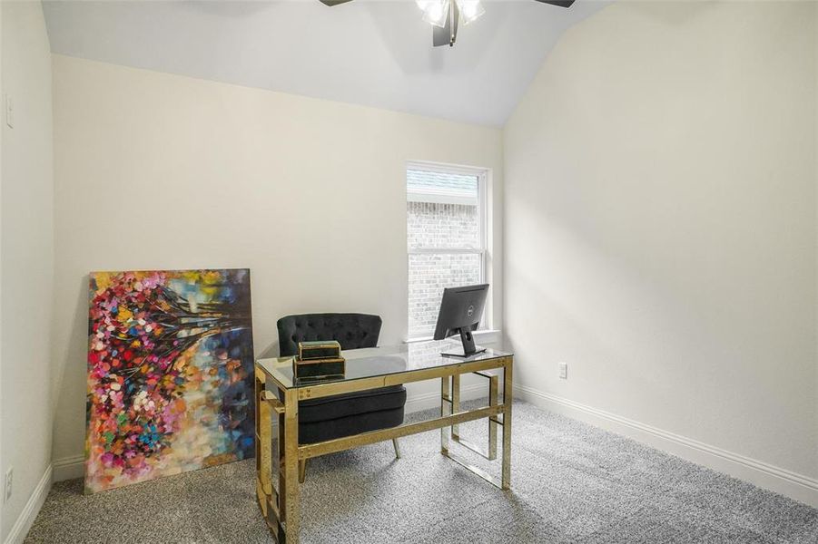 Carpeted office with ceiling fan and lofted ceiling