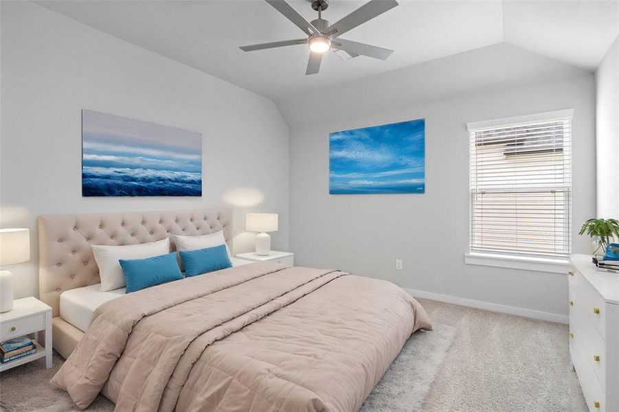 Secondary bedroom features plush carpet, custom paint, ceiling fan with lighting and a large window with privacy blinds.