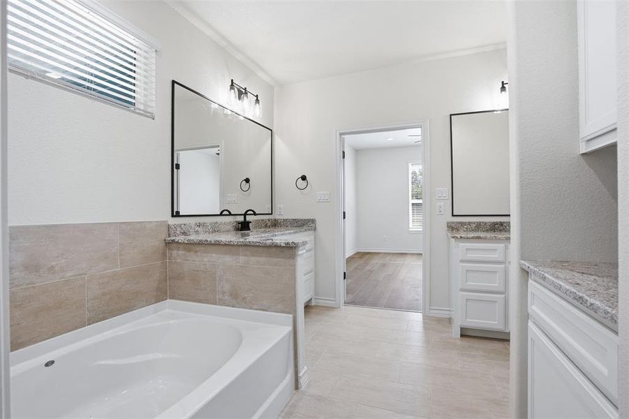 Full bathroom with vanity and a garden tub Full bathroom with vanity and a garden tub