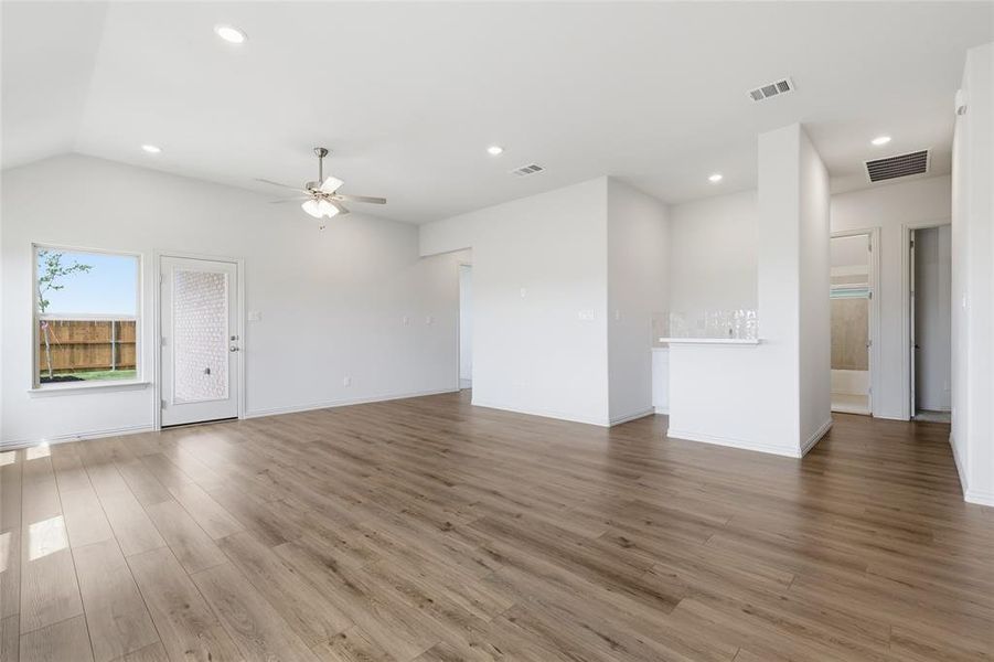 Unfurnished living room featuring a ceiling fan, recessed lighting, light wood-style flooring, and lofted ceiling
