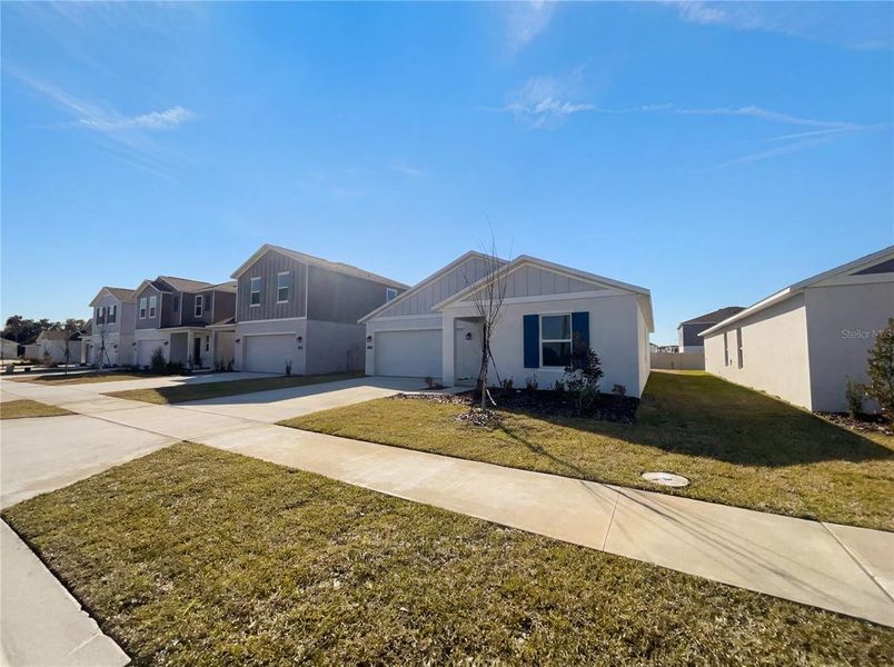 Front exterior of a new home in Peace Creek Reserve, Winter Haven, FL, highlighting curb appeal (Image 2).