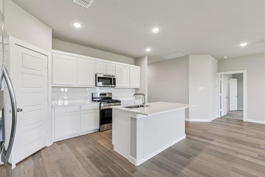 Kitchen in the Harper home plan by Trophy Signature Homes – REPRESENTATIVE PHOTO