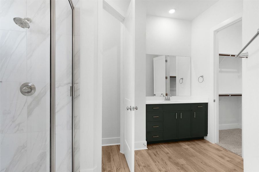 Well-appointed bathroom showcasing a spacious shower with sleek tile and a large vanity.
