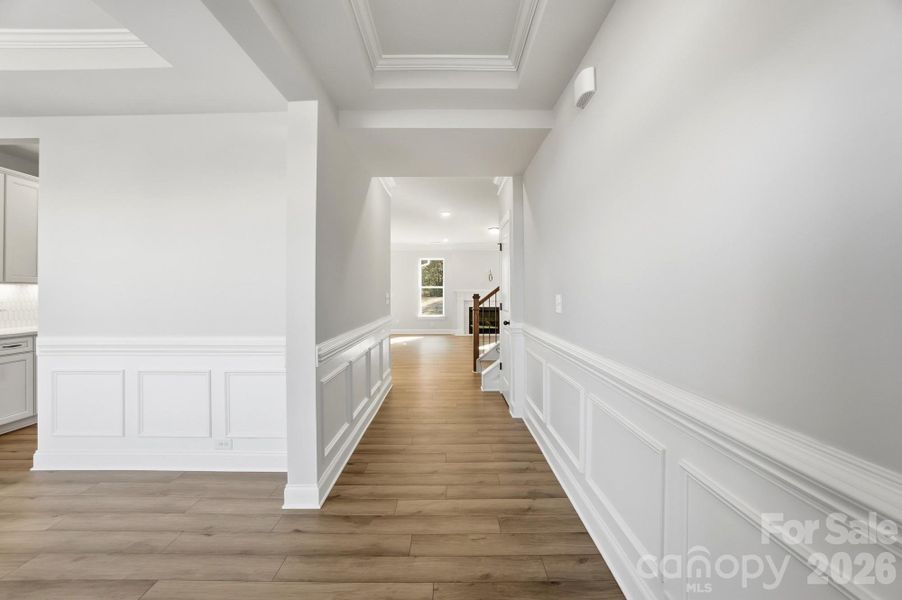 Foyer with tray ceiling & wainscoting