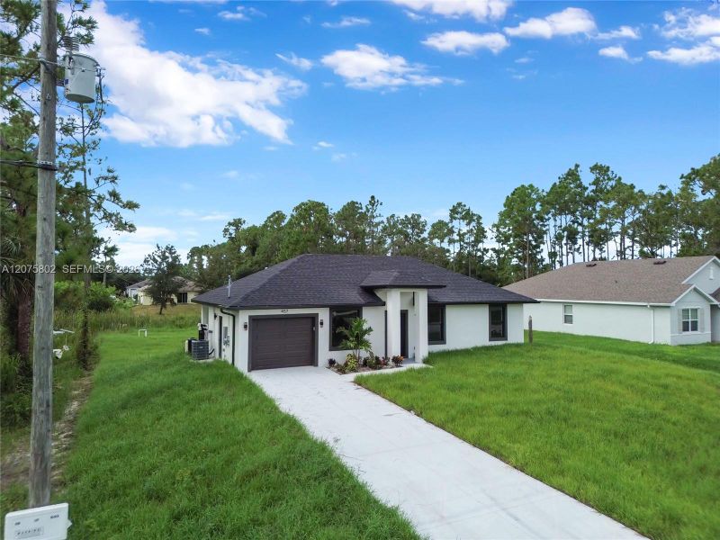Front exterior of a new home in , Lehigh Acres, FL, highlighting curb appeal (Image 20).