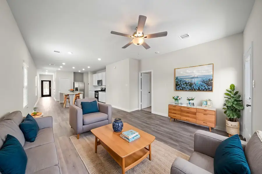 A living room with a ceiling fan.