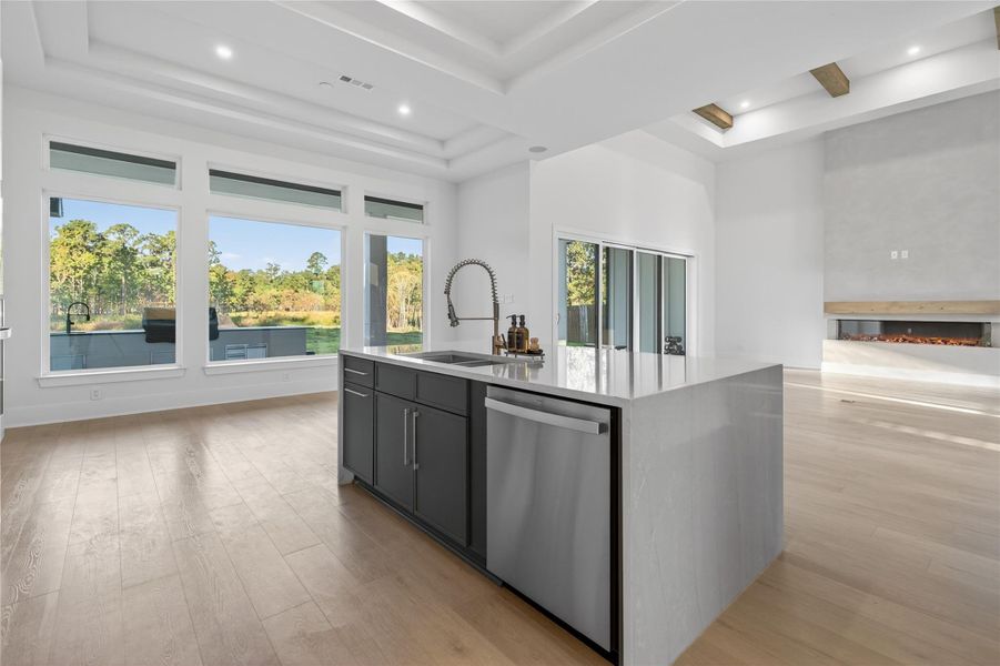 Large windows fill the kitchen with natural light while the oversized island offers ample prep and gathering space. **Images are from a previously completed project. **