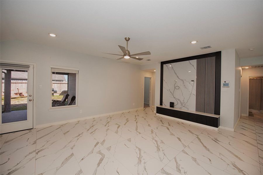 Family room features a custom wall with stunning woodwork and marble for setting up your entertainment system. Family room features a custom wall with stunning woodwork and marble for setting up your entertainment system.
