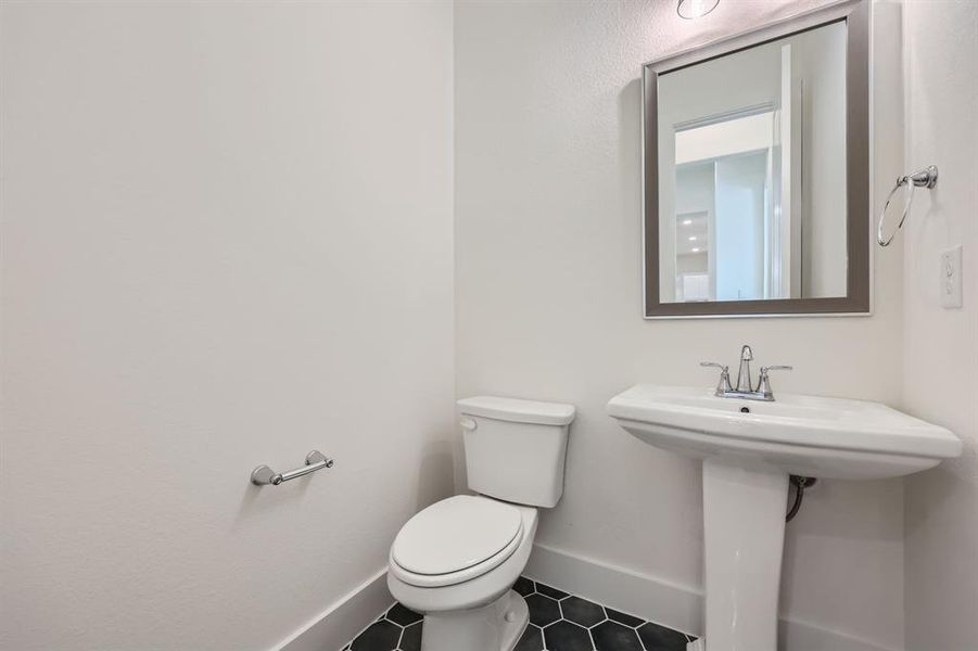 Bathroom featuring toilet and tile patterned floors