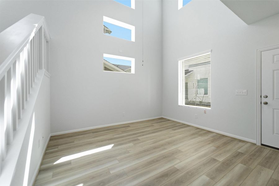Entryway featuring light wood-style floors and a high ceiling