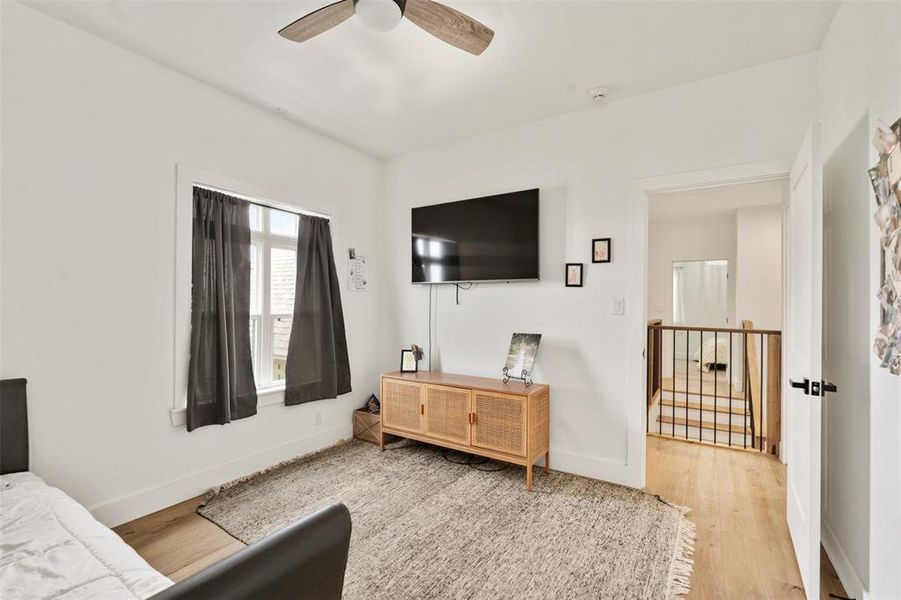 Bedroom with wood finished floors and ceiling fan