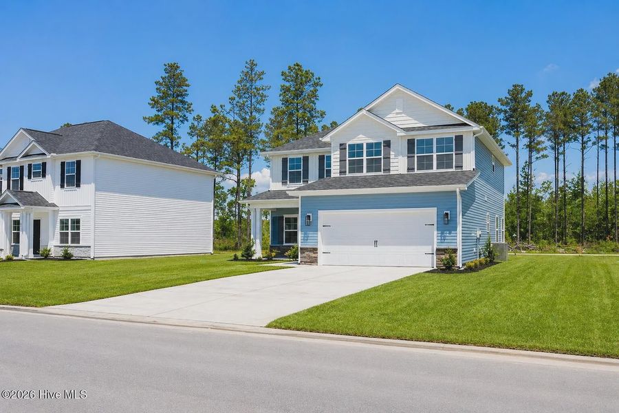 Front exterior of a new home in Patriot Pointe, Jacksonville, NC, highlighting curb appeal (Image 2). Front exterior of a new home in Patriot Pointe, Jacksonville, NC, highlighting curb appeal (Image 2).
