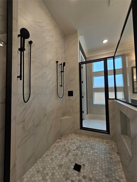 This photo showcases a modern, elegant shower with marble-style tiles, dual black showerheads, and a glass door. The space is bright and sophisticated, offering a luxurious bathing experience. This photo showcases a modern, elegant shower with marble-style tiles, dual black showerheads, and a glass door. The space is bright and sophisticated, offering a luxurious bathing experience.