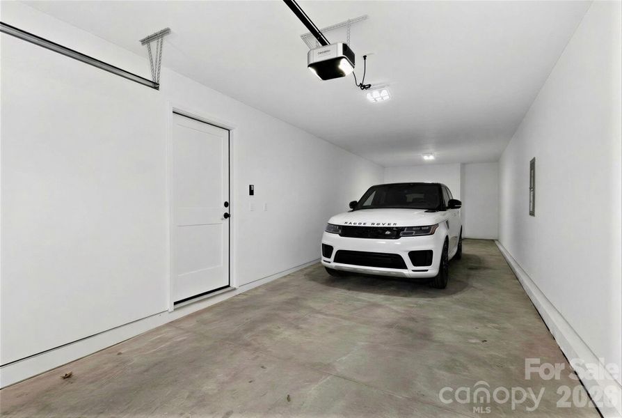 Tandem garage with virtually added vehicle for effect.