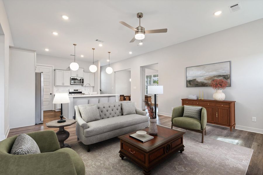 Open concept living area with wood-finish flooring, recessed lighting, and a ceiling fan